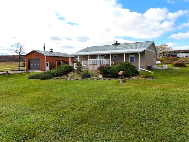 rear view of house with covered porch and a lawn