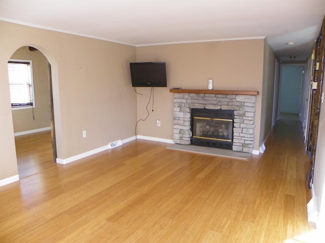 unfurnished living room featuring crown molding, wood-type flooring, and a fireplace