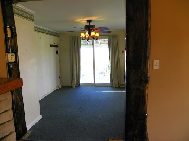 unfurnished room featuring ceiling fan and dark colored carpet