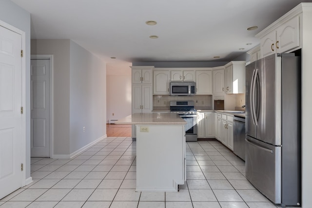 kitchen featuring light tile patterned flooring, stainless steel appliances, a center island, and tasteful backsplash