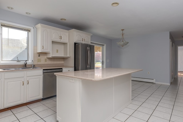 kitchen with a kitchen island, white cabinetry, backsplash, baseboard heating, and stainless steel appliances