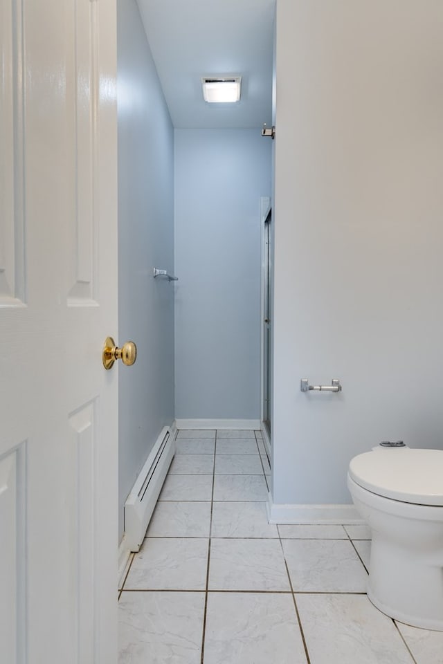 bathroom featuring tile patterned flooring, a baseboard heating unit, a shower with shower door, and toilet