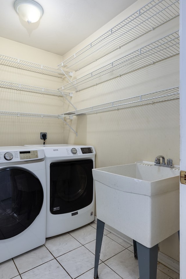 clothes washing area featuring tile patterned floors and independent washer and dryer