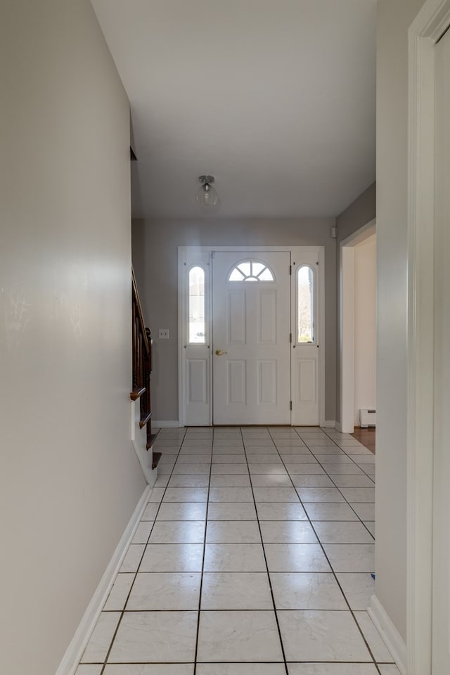 foyer entrance with light tile patterned floors