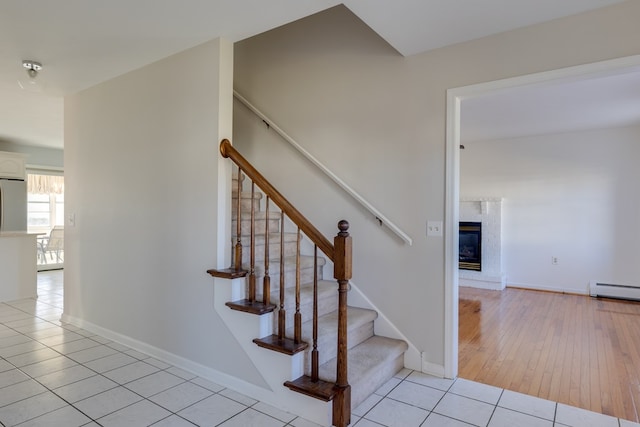 stairway with tile patterned flooring and baseboard heating