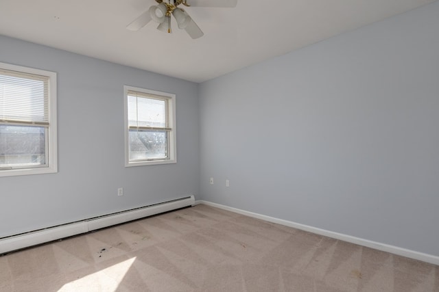 carpeted empty room with a baseboard heating unit and ceiling fan