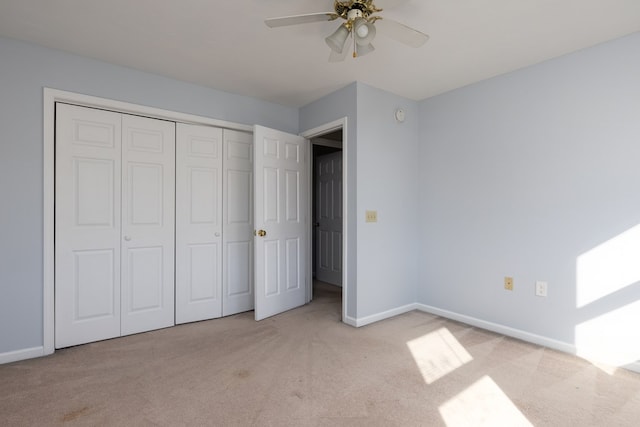 unfurnished bedroom with light colored carpet, ceiling fan, and a closet