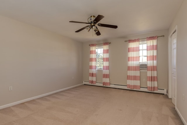 unfurnished room with ceiling fan, a baseboard radiator, light carpet, and a wealth of natural light