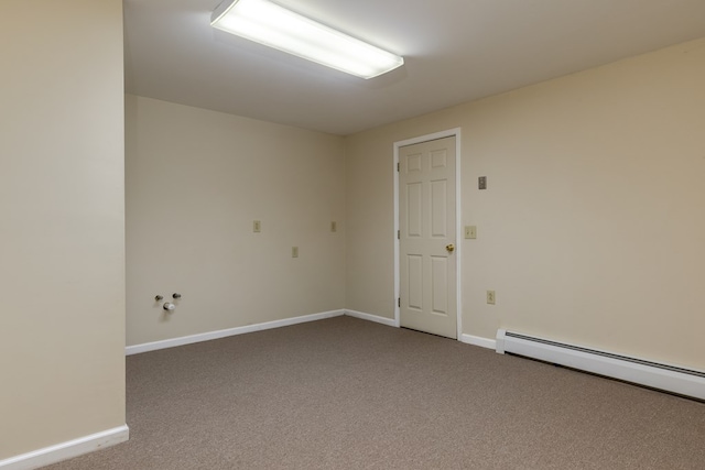 carpeted spare room with a baseboard radiator