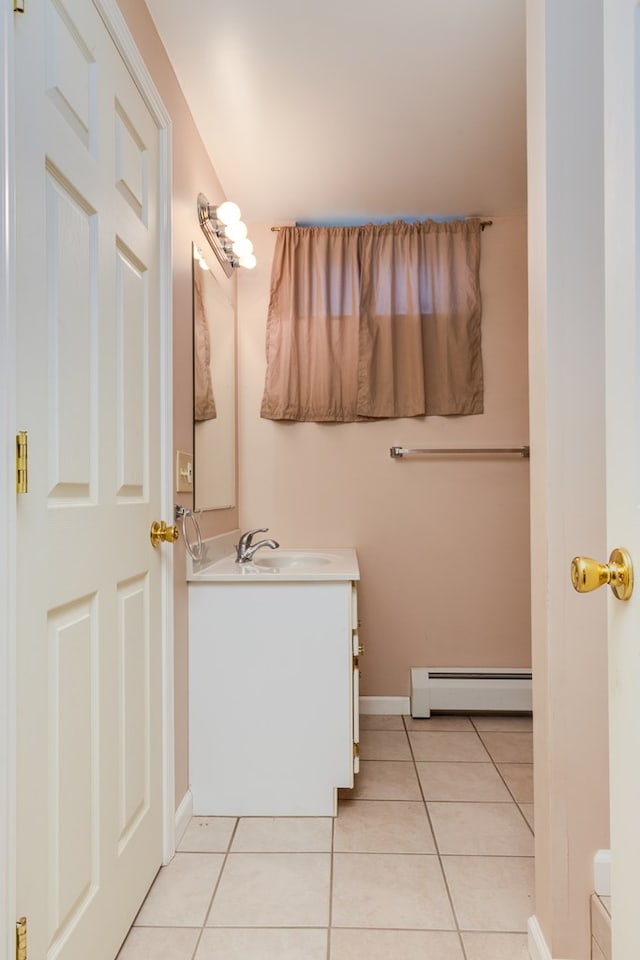 bathroom with tile patterned flooring, vanity, and a baseboard heating unit