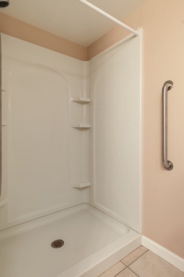 bathroom featuring a shower and tile patterned floors