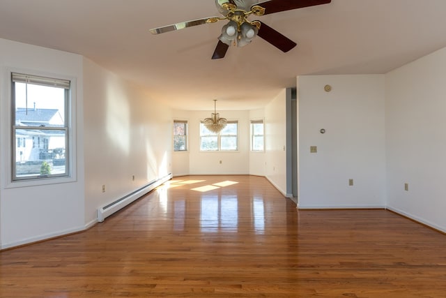 spare room with a baseboard radiator, wood-type flooring, and ceiling fan with notable chandelier