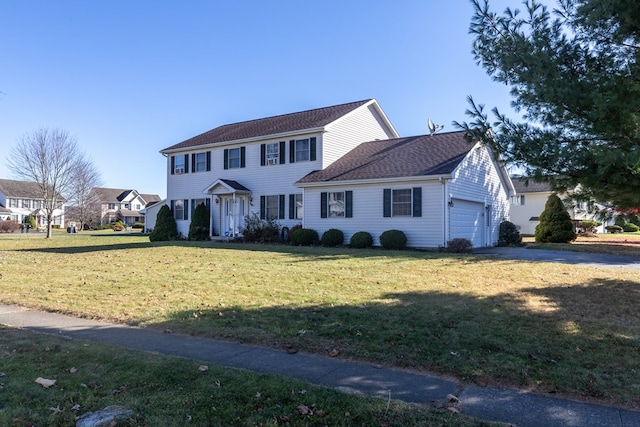 colonial home with a garage and a front yard