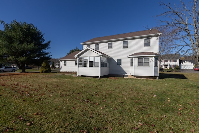 rear view of property with a lawn