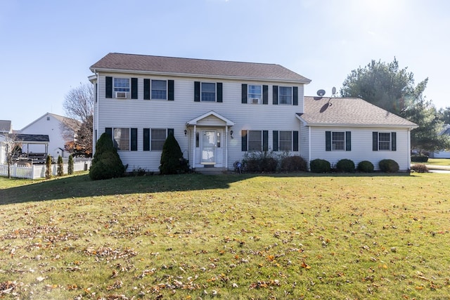 colonial-style house with cooling unit and a front lawn