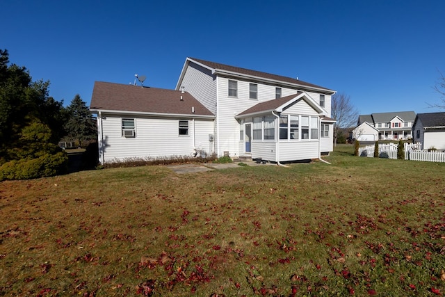 back of house featuring a sunroom and a yard