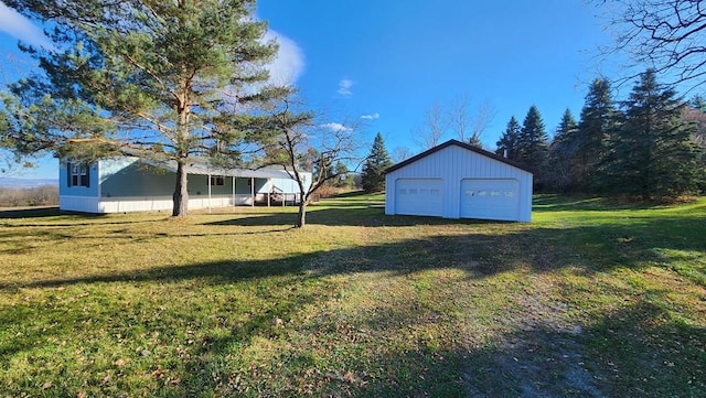 view of yard with a garage and an outdoor structure