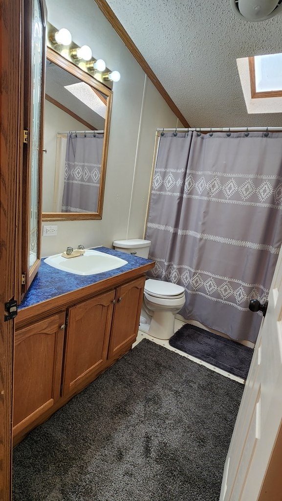 bathroom with walk in shower, ornamental molding, vanity, a textured ceiling, and toilet