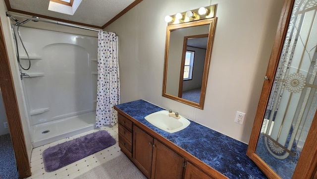 bathroom with tile patterned flooring, a shower with shower curtain, a textured ceiling, vanity, and ornamental molding