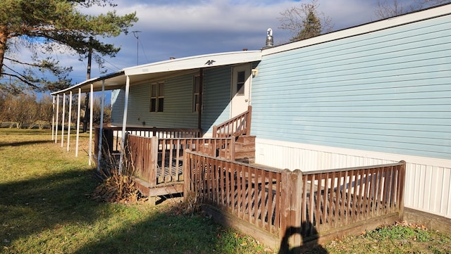 wooden terrace with a yard