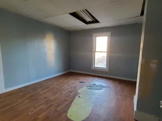 unfurnished room featuring a paneled ceiling and wood-type flooring