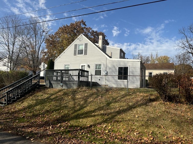 back of house with a yard and a wooden deck