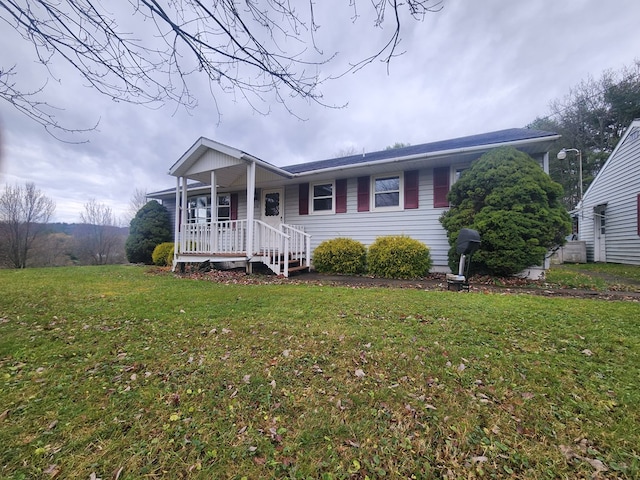 view of front of home with a porch and a front lawn