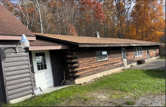 view of property exterior with a yard