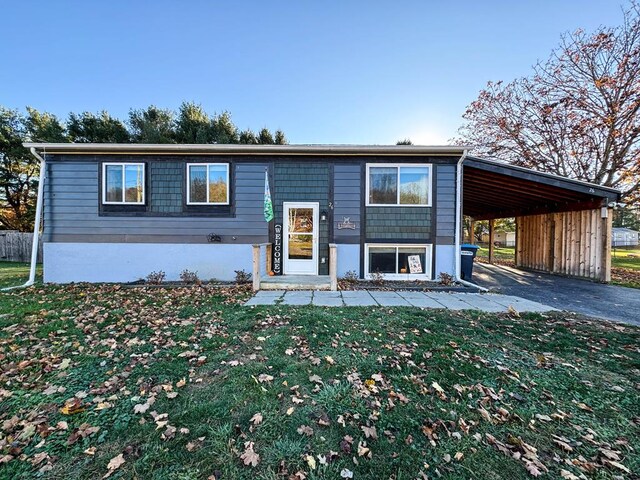 view of front facade with a carport and a front yard