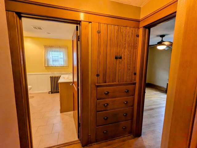 corridor with radiator and light hardwood / wood-style floors