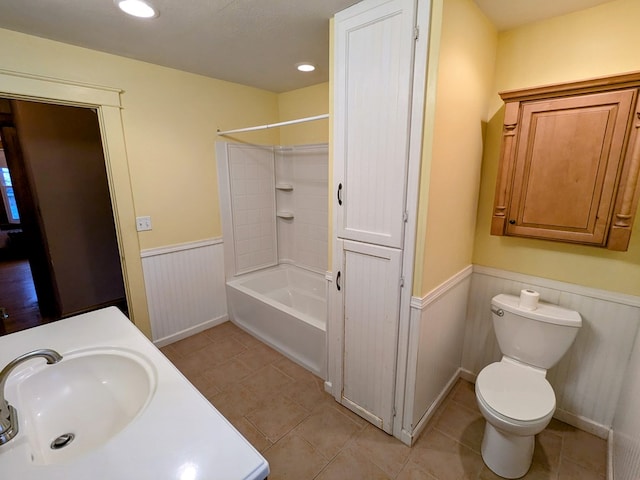 full bathroom with tub / shower combination, sink, tile patterned floors, and toilet