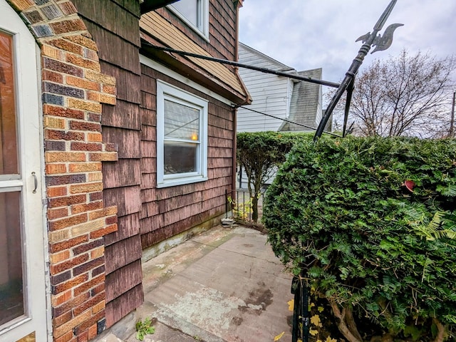 view of side of home with a patio area