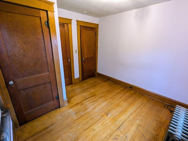 unfurnished bedroom with light wood-type flooring