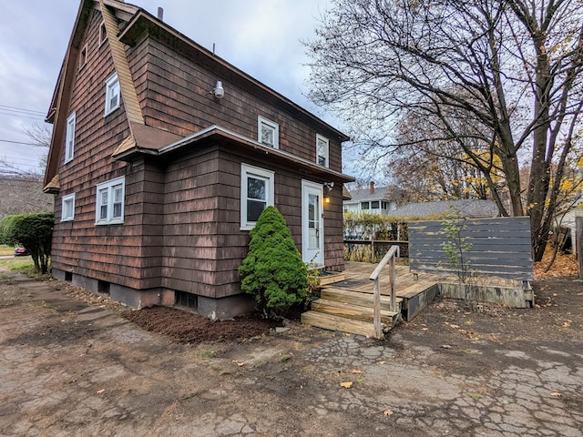 rear view of property with a wooden deck