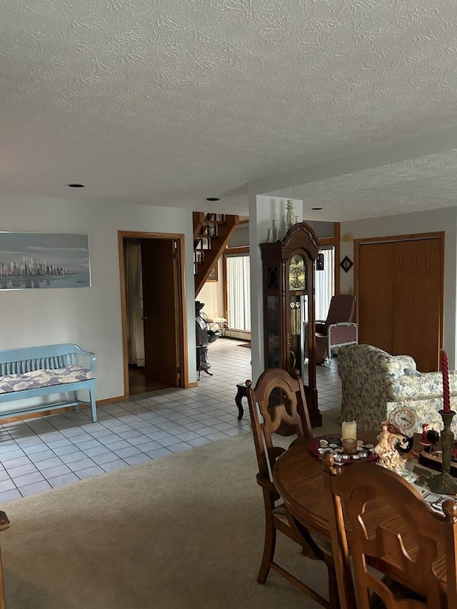 unfurnished dining area featuring a textured ceiling and light colored carpet