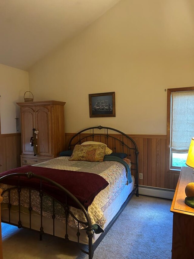 bedroom with dark carpet, a baseboard radiator, and vaulted ceiling