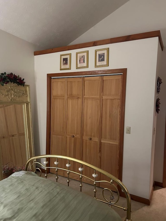 unfurnished bedroom with light colored carpet and vaulted ceiling