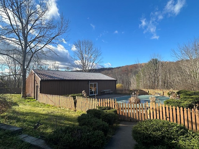 exterior space featuring a yard and an outdoor structure