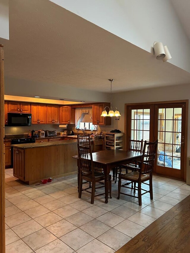 tiled dining space featuring french doors