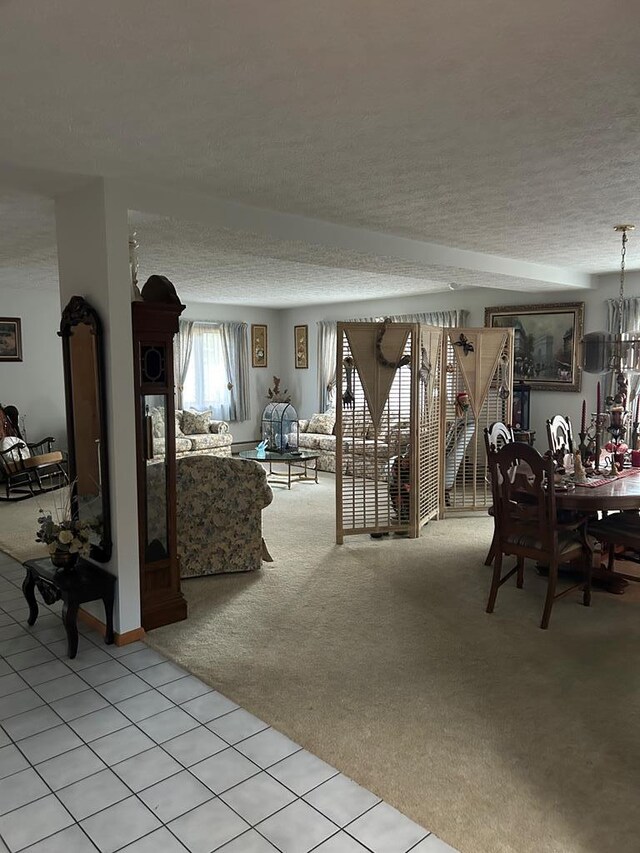 carpeted dining room with a textured ceiling