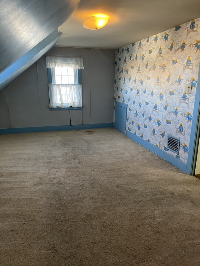 additional living space with carpet floors and lofted ceiling