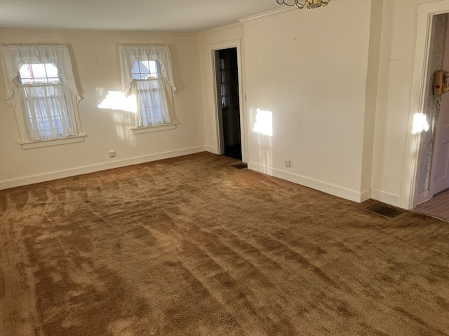 unfurnished room with dark colored carpet and ornamental molding