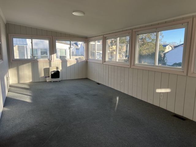 unfurnished sunroom featuring lofted ceiling and heating unit