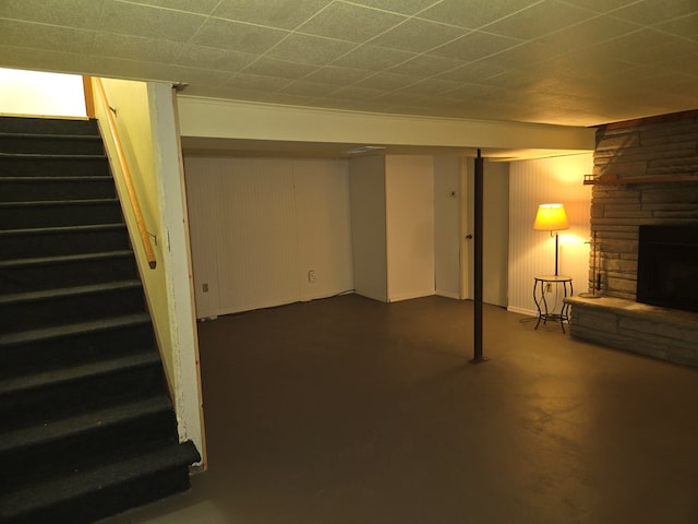 basement with a stone fireplace