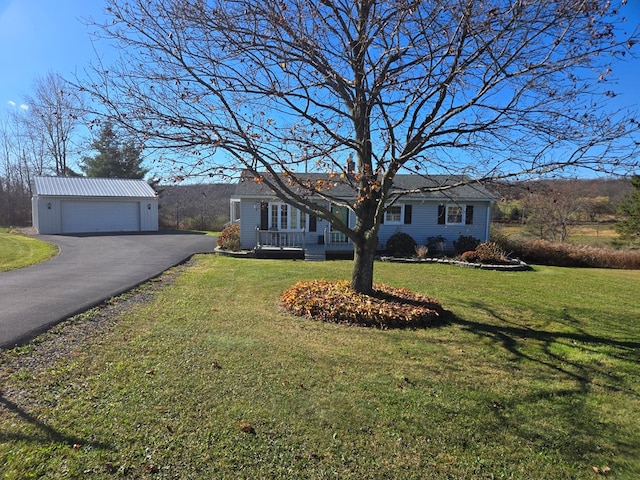 single story home with a garage, an outdoor structure, and a front yard