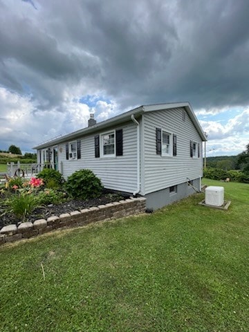 view of property exterior with a lawn