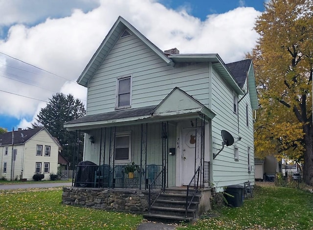 view of front of home with covered porch and a front yard