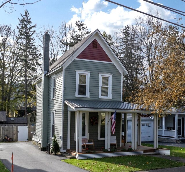 view of front of house featuring a porch and a garage