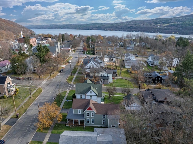 drone / aerial view with a water and mountain view