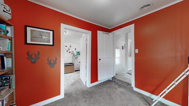 hallway featuring carpet flooring and crown molding